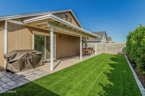 a view of a chair and table in backyard