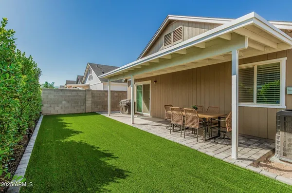 a front view of house with yard and outdoor seating