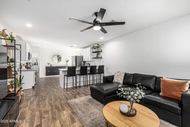 a living room with furniture and a wooden floor