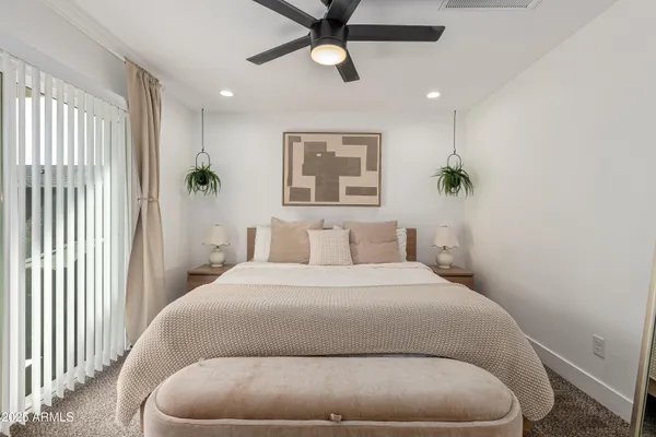 a bedroom with a bed and window