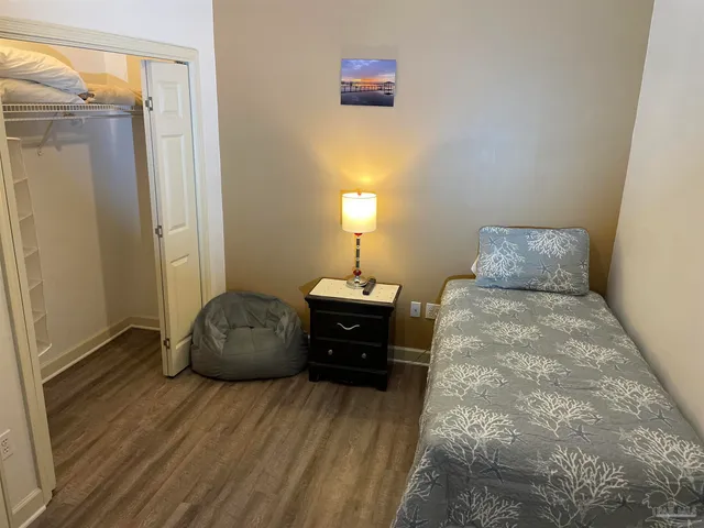 a bedroom with a bed and a mirror