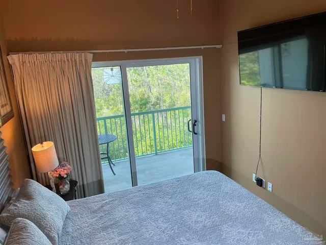 a view of a bedroom with furniture and windows