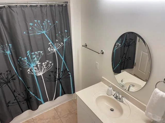a bathroom with a sink mirror and vanity