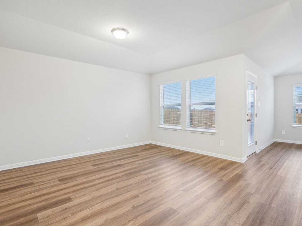 104 Honey Bee Road Jarrell, TX 76537 - Photo 9 of 17 wooden floor in an empty room with a window