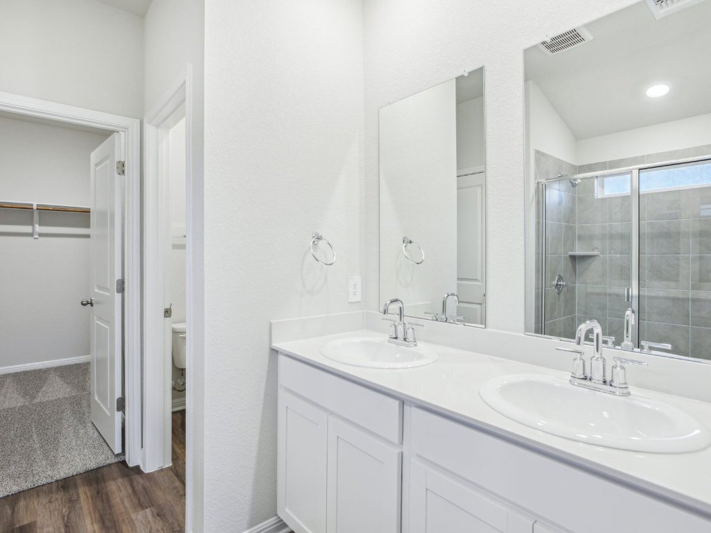 104 Honey Bee Road Jarrell, TX 76537 - Photo 12 of 17 a bathroom with a sink and a mirror