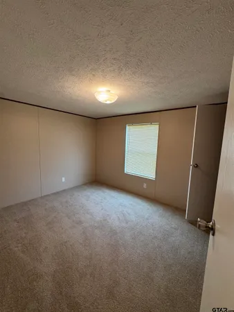 a bathroom with a granite countertop sink toilet a mirror and shower