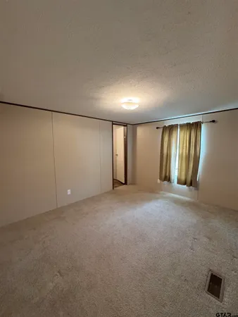 a view of an empty room with windows