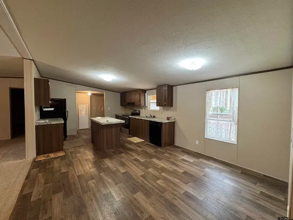 a large kitchen with a lot of counter space and stainless steel appliances