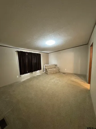 a view of an empty room with furniture