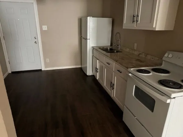 a kitchen with a stove and a refrigerator