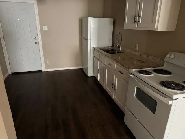 a kitchen with a stove and a refrigerator
