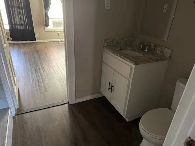 a bathroom with a granite countertop sink toilet and a tub