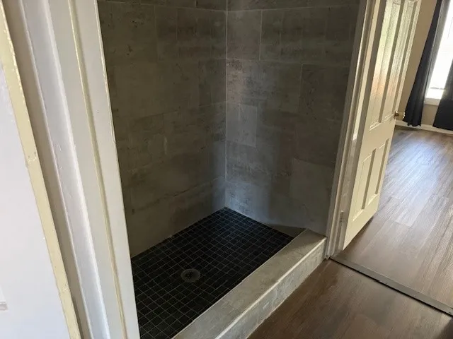 a bathroom with a glass door shower