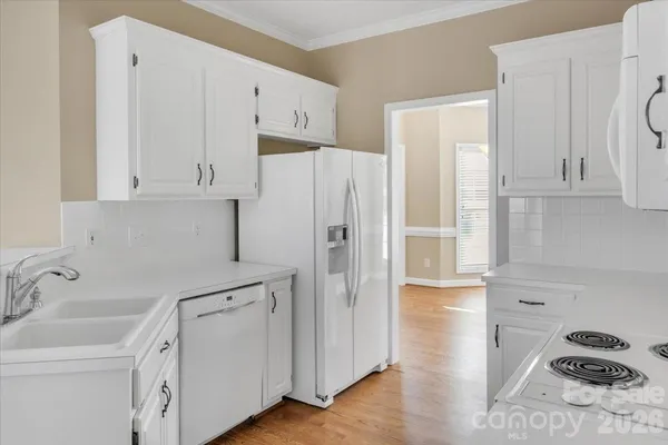 a kitchen with stainless steel appliances white cabinets and a sink