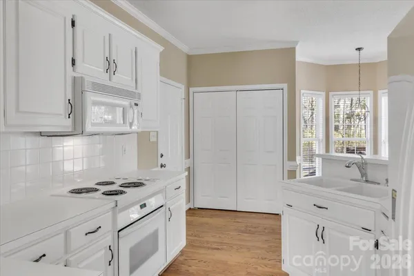 a kitchen with stainless steel appliances white cabinets and a sink