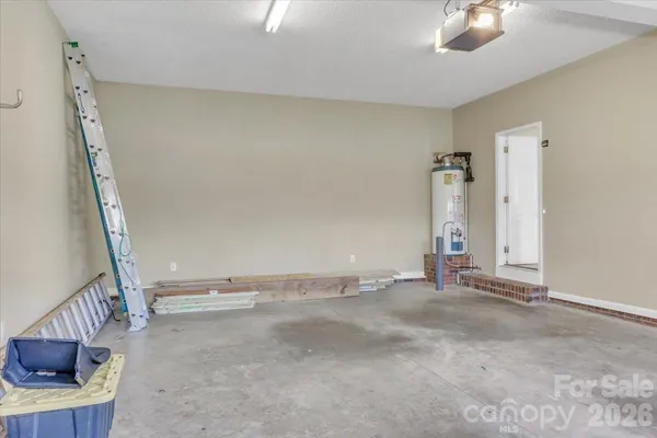 a view of an empty room with wooden floor and staircase