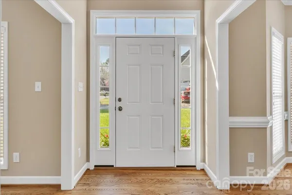 a view of an entryway with wooden floor