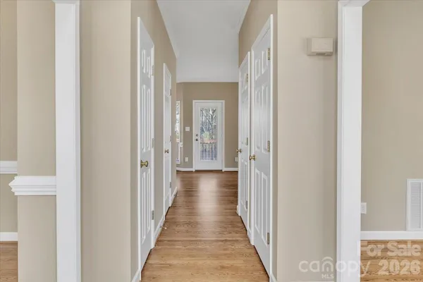 a view of a hallway with a wooden door