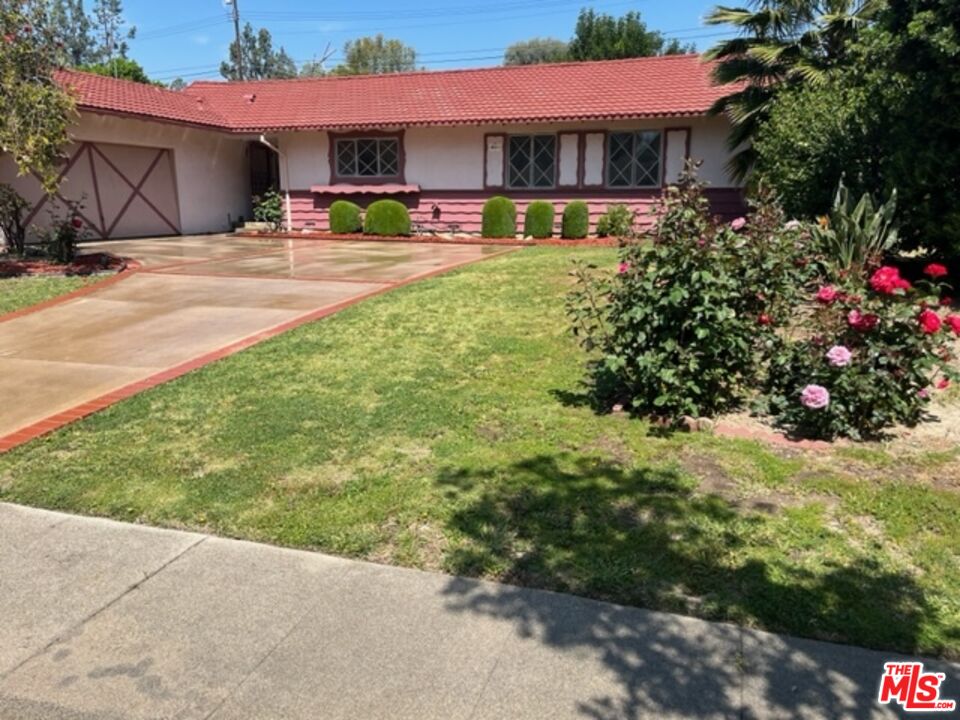 18665 Horace Street Porter Ranch, CA 91326 - Photo 1 of 13 a front view of a house with yard and green space