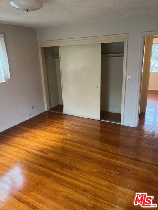 18665 Horace Street Porter Ranch, CA 91326 - Photo 11 of 13 a view of an empty room with wooden floor and a window
