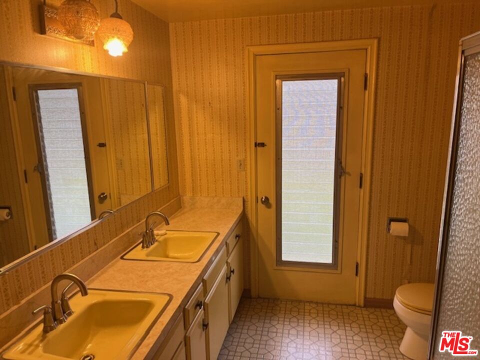 18665 Horace Street Porter Ranch, CA 91326 - Photo 13 of 13 a bathroom with a sink and a toilet