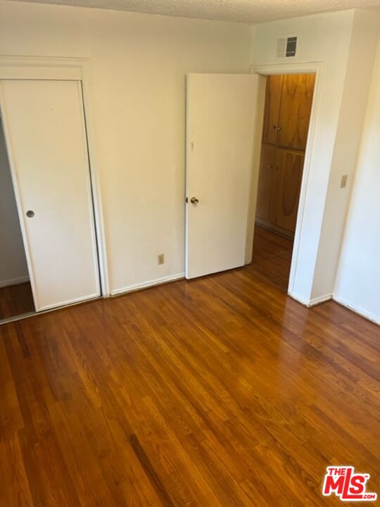 18665 Horace Street Porter Ranch, CA 91326 - Photo 6 of 13 an empty room with wooden floor
