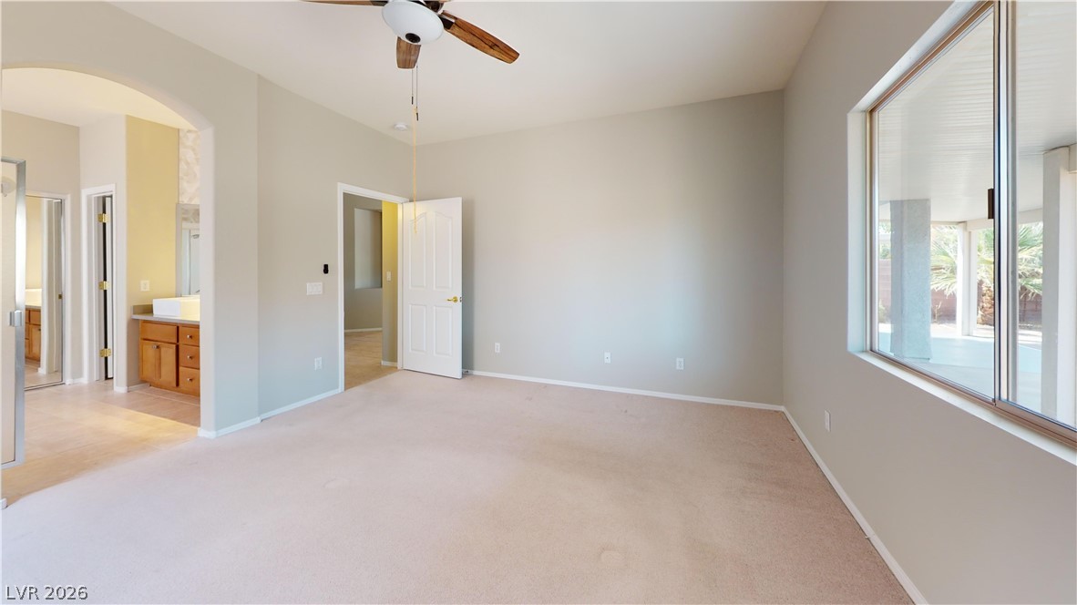 3591 Driving Range Street Las Vegas, NV 89122 - Photo 75 of 79 This spacious bedroom offers ample natural light and direct access to a private bathroom.