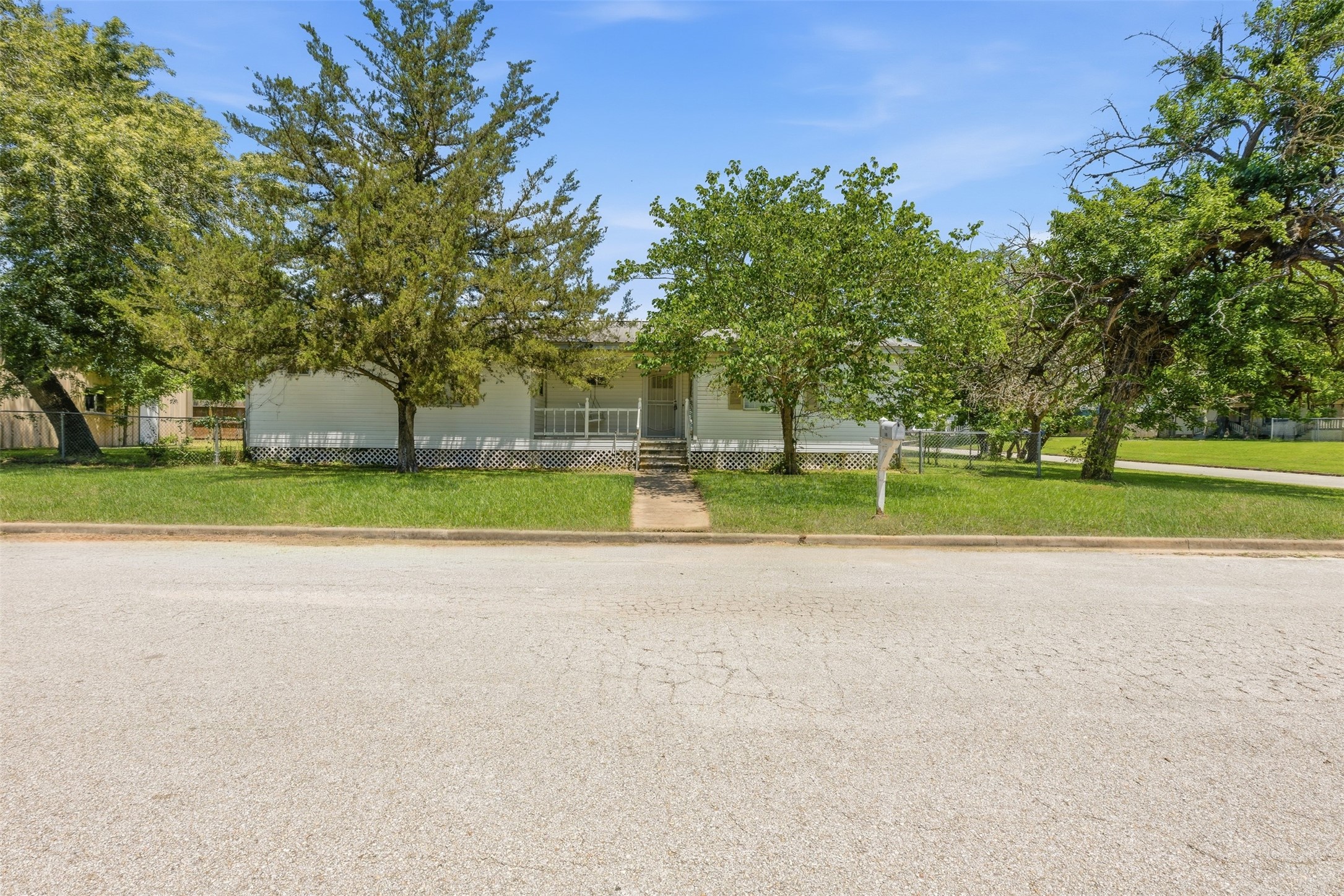 1310 Brazos Street Hempstead, TX 77445 - Photo 27 of 32 a view of a house with a big yard and a large trees
