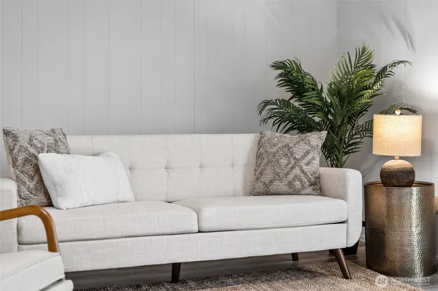a living room with furniture and a potted plant