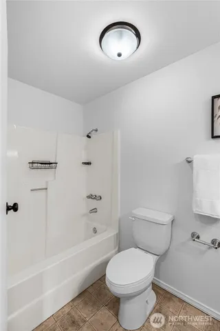 a bathroom with a toilet a sink a bath tub and a shower