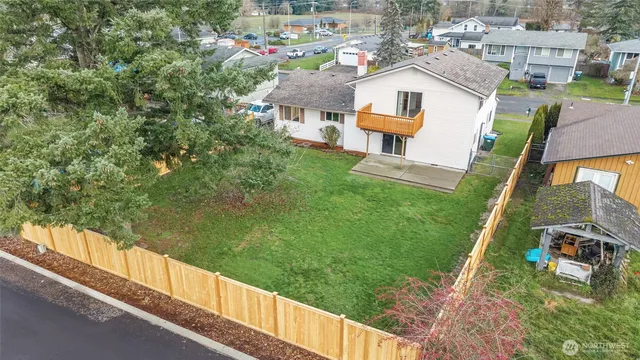 a view of residential houses with outdoor space and trees