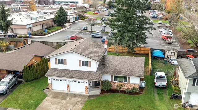 a aerial view of a house with a yard and sitting area