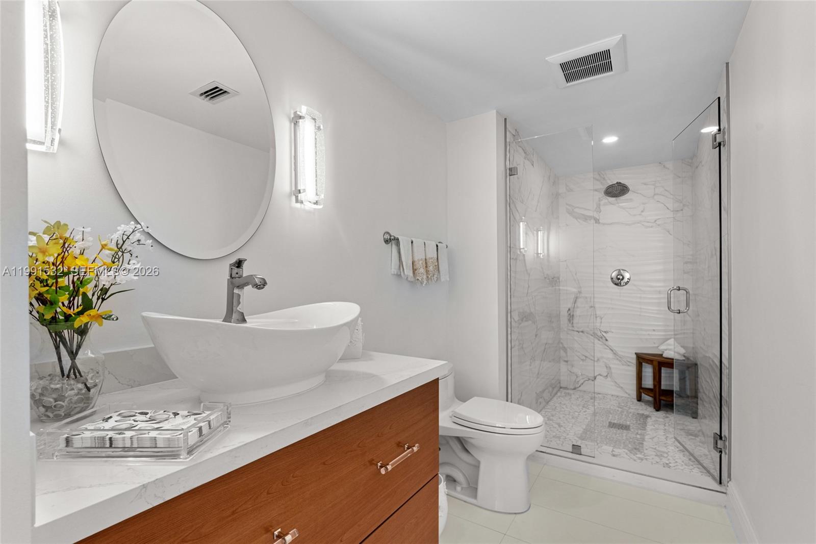9801 Collins Avenue, Unit 5R Bal Harbour, FL 33154 - Photo 20 of 47 a bathroom with a sink a toilet and shower