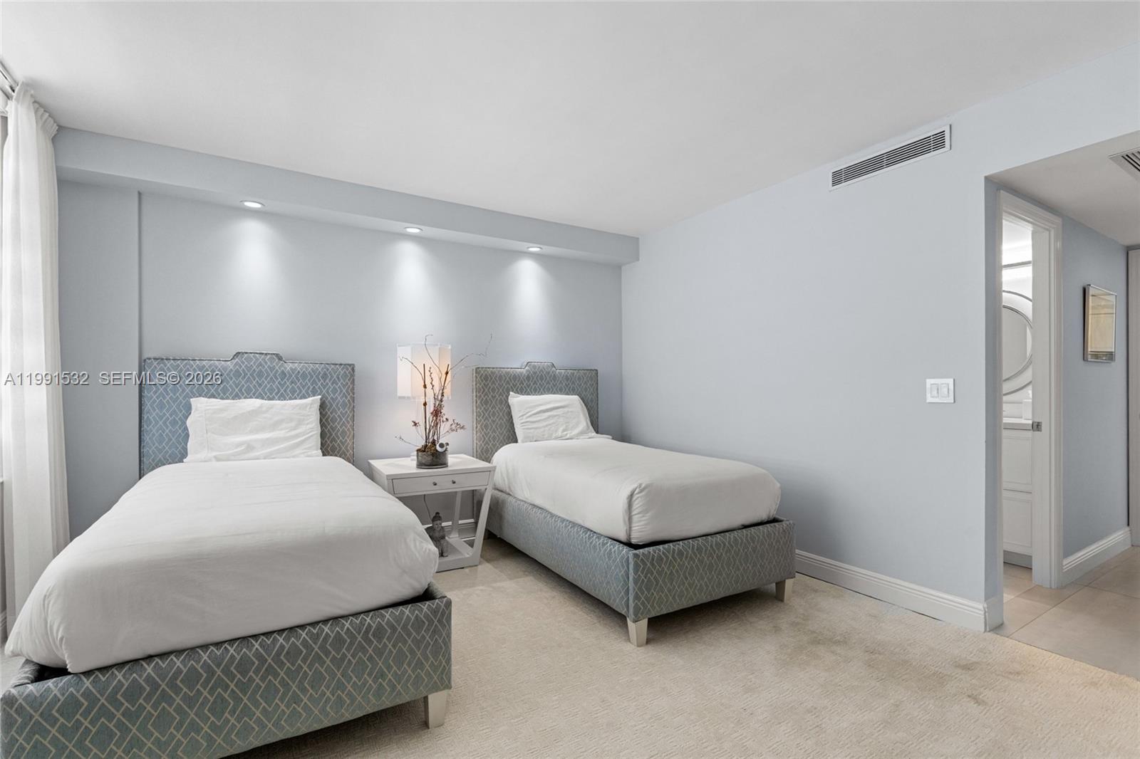 9801 Collins Avenue, Unit 5R Bal Harbour, FL 33154 - Photo 22 of 47 a bedroom with two beds and painted walls
