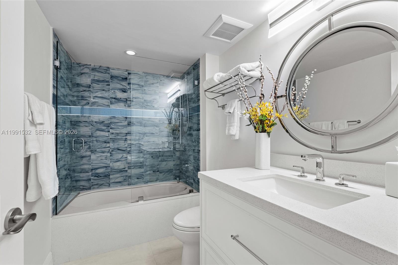 9801 Collins Avenue, Unit 5R Bal Harbour, FL 33154 - Photo 23 of 47 a bathroom with a sink a toilet and bathtub