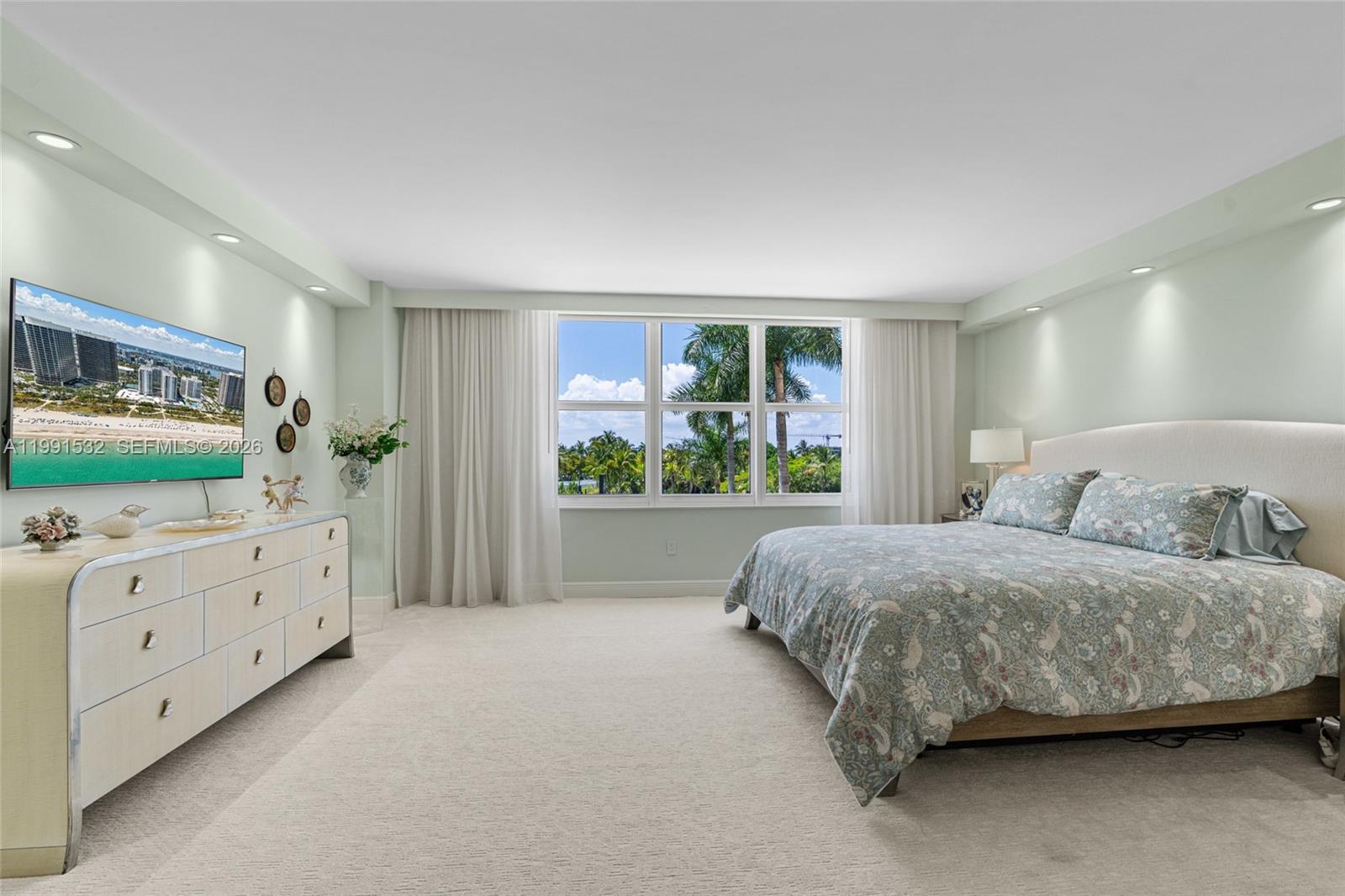 9801 Collins Avenue, Unit 5R Bal Harbour, FL 33154 - Photo 25 of 47 a room with a bed mirror on dresser and a window