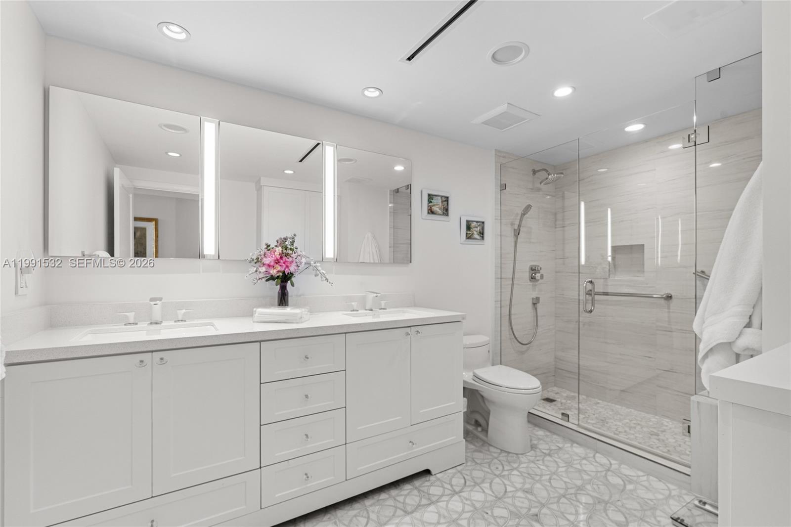 9801 Collins Avenue, Unit 5R Bal Harbour, FL 33154 - Photo 27 of 47 a bathroom with a double vanity sink mirror and toilet