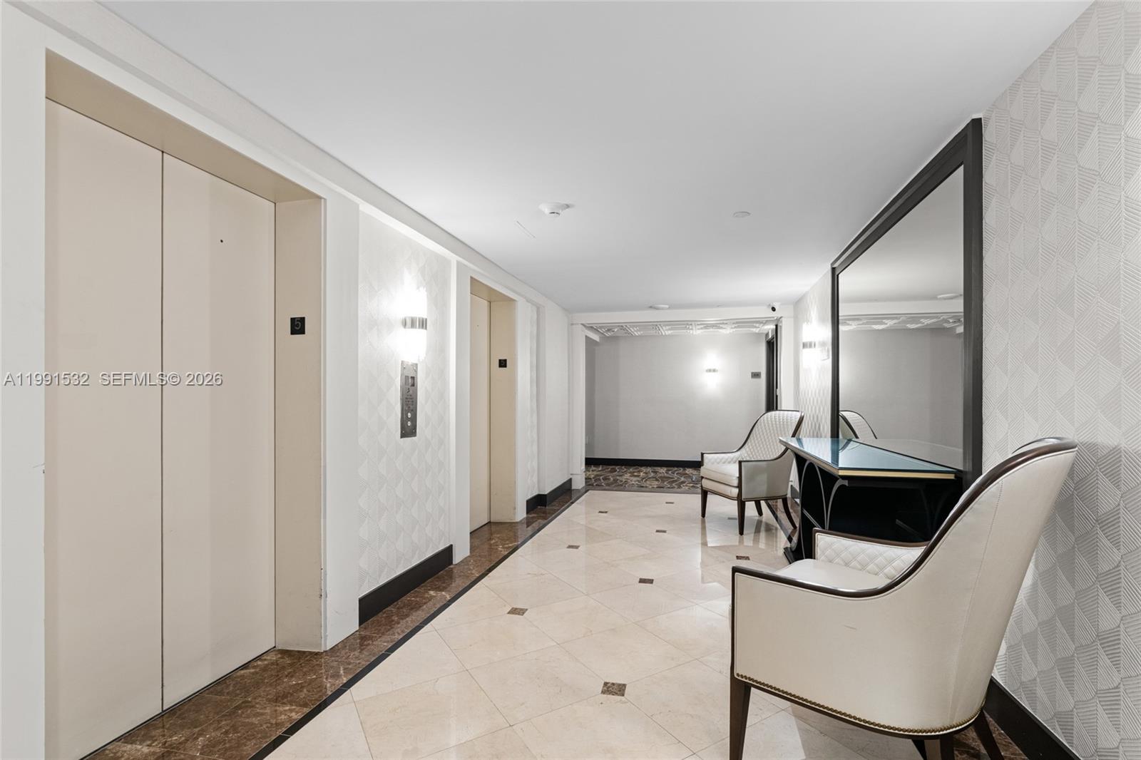 9801 Collins Avenue, Unit 5R Bal Harbour, FL 33154 - Photo 4 of 47 a view of a hallway with a large mirror
