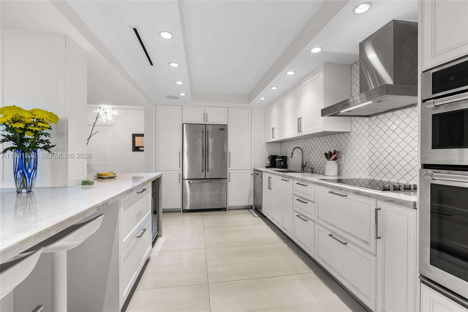 9801 Collins Avenue, Unit 5R Bal Harbour, FL 33154 - Photo 10 of 47 a kitchen with cabinets and white appliances