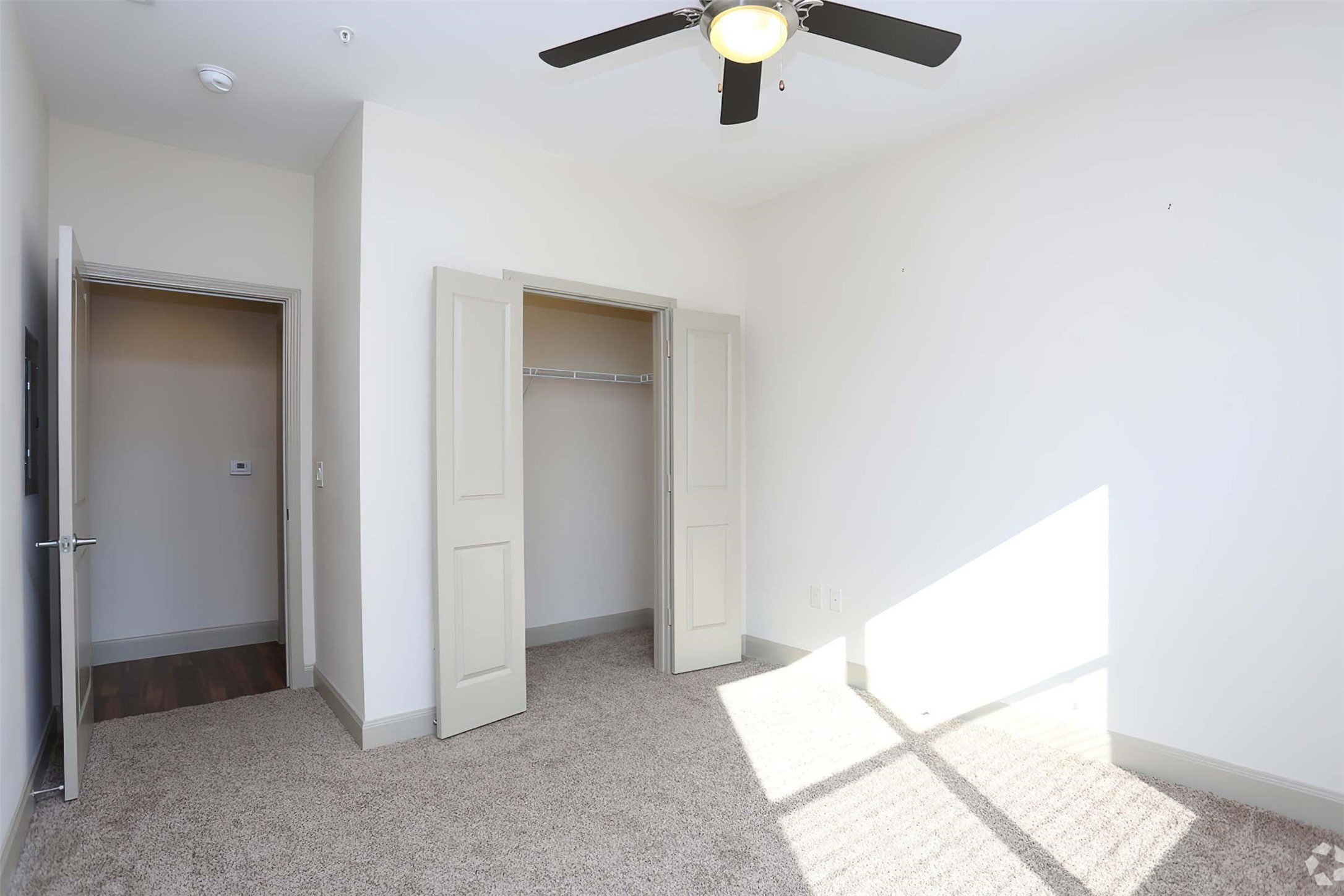 4604 Cypresswood Drive, Unit 1112 Spring, TX 77379 - Photo 19 of 29 an empty room with a ceiling fan and a window