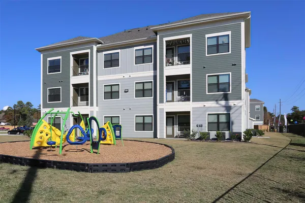 a front view of a residential apartment building with a yard