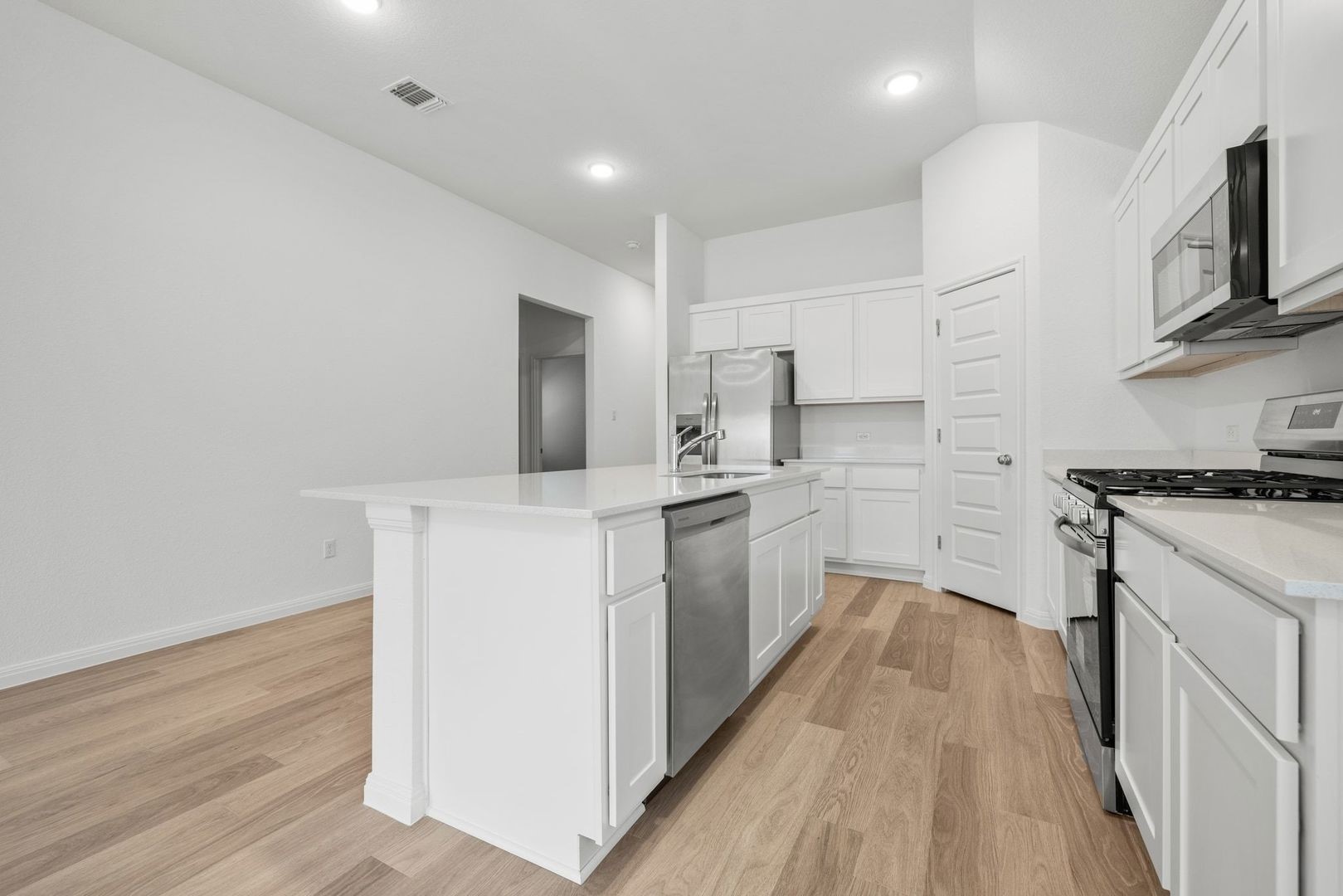 222 Spirit Street Elgin, TX 78621 - Photo 9 of 40 a kitchen with cabinets and wooden floor