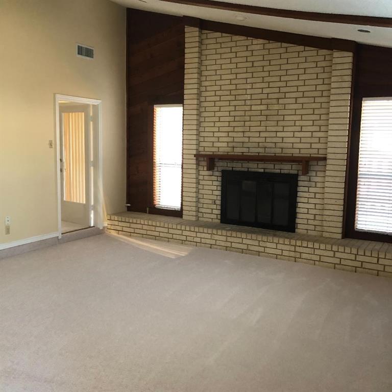 222 Syracuse Place Richardson, TX 75081 - Photo 2 of 13 a view of an empty room with a fireplace and a window