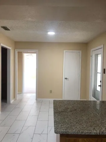 a view of livingroom with hardwood floor and kitchen