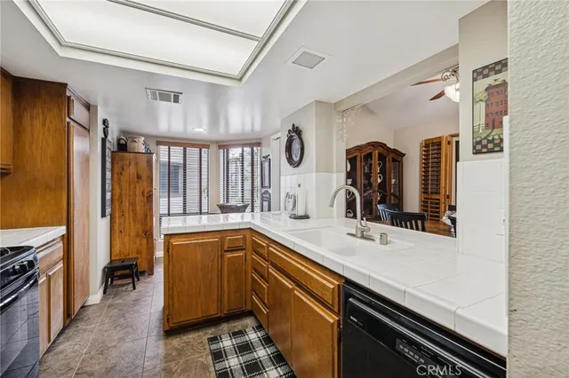 a kitchen with a sink appliances and cabinets