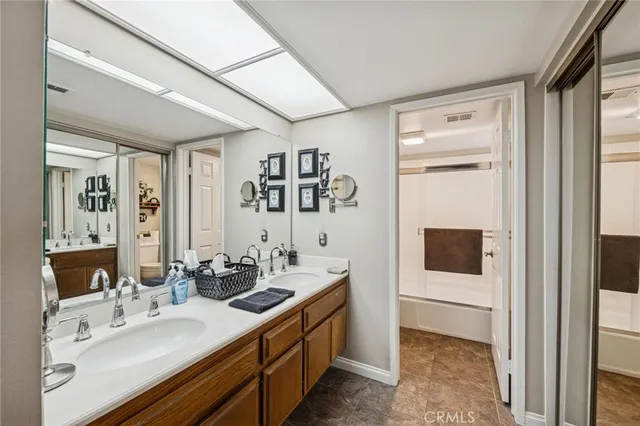 a en suite bathroom with a sink a mirror and shower