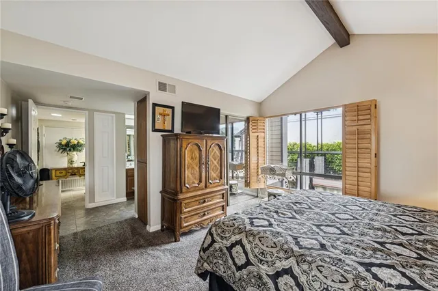 a bedroom with a bed and a television