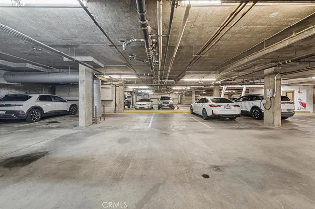 a view of parking garage with cars parked