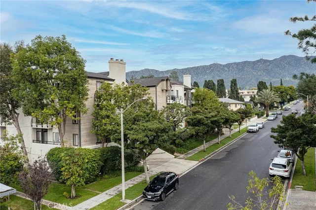 a view of a chair and tables in the backyard of the house