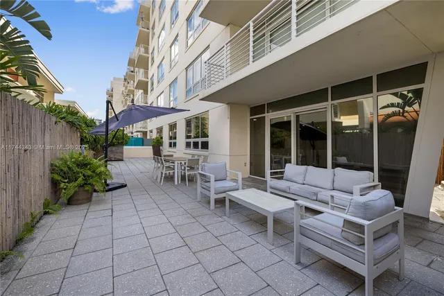 a view of a patio with couches table and chairs and potted plants